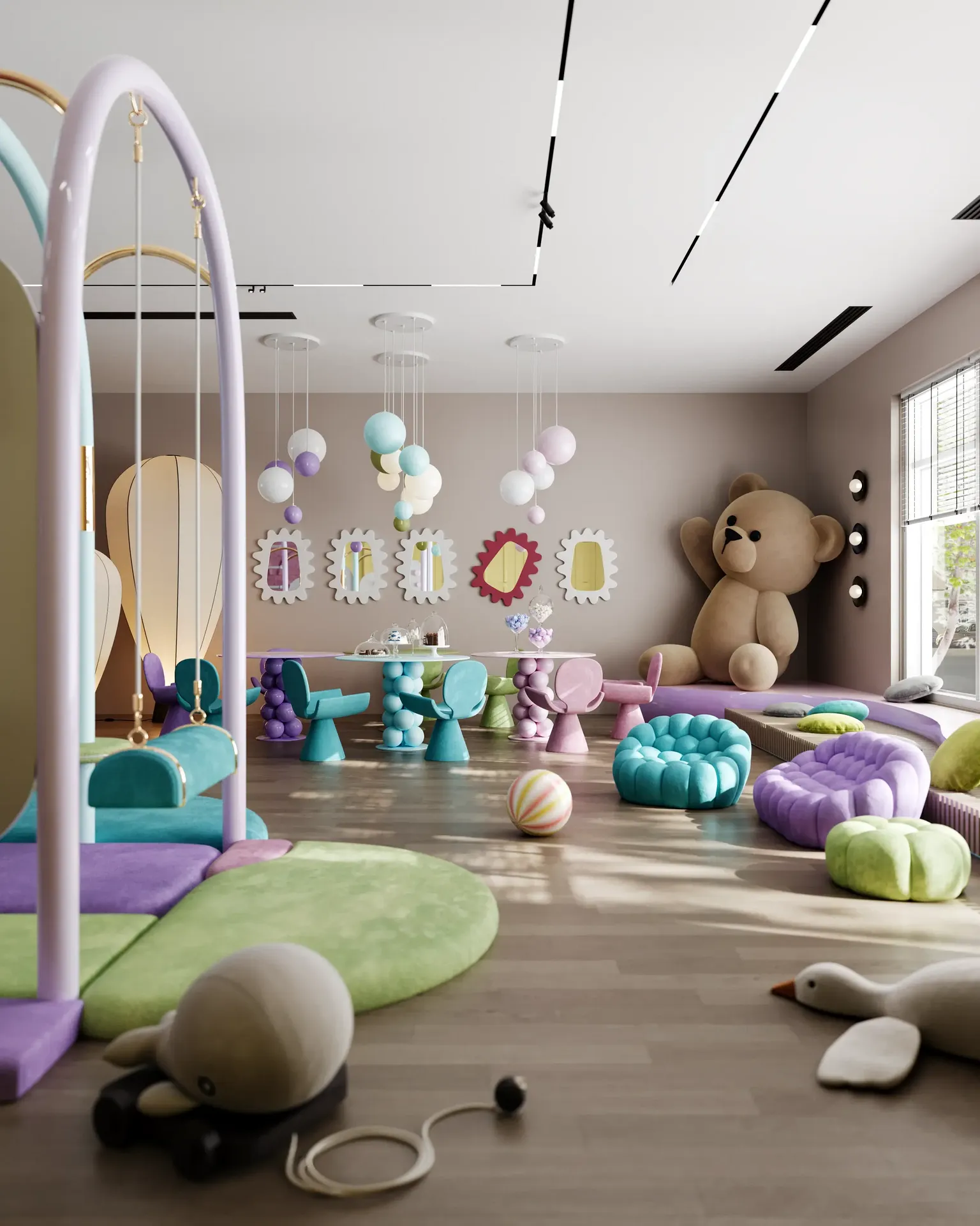 Spacious soft play zone in a children's center, featuring a climbing wall, colorful toys, and soft armchairs.