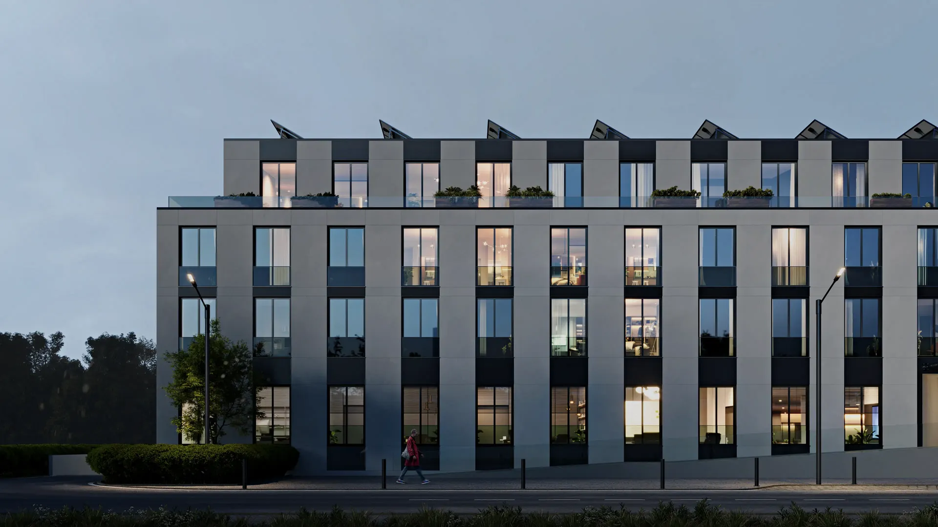 Striking frontal evening shot of the modern Adlershof residential complex, warmly illuminated.