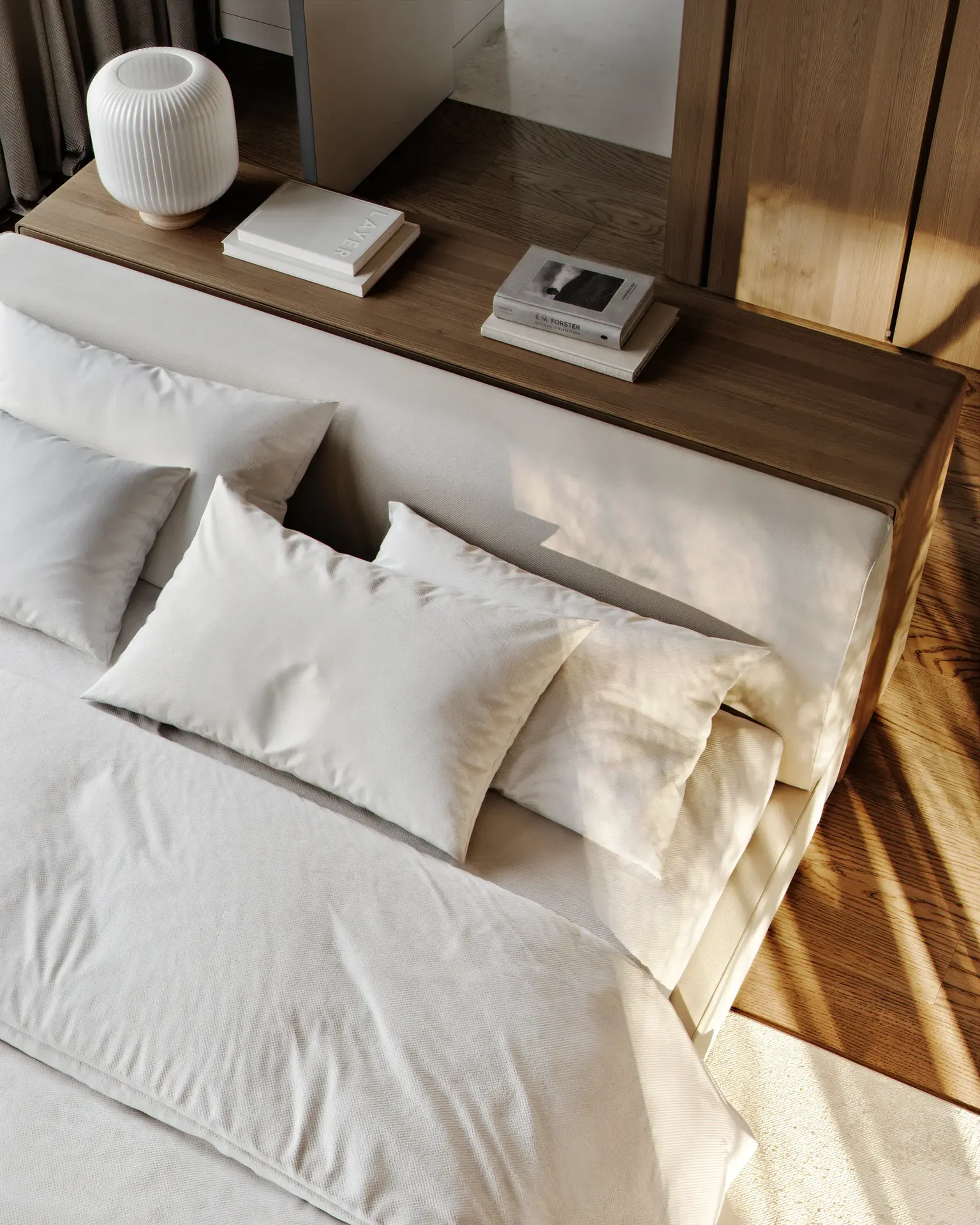 Minimalist modern bedroom styling details. 3D visualization of a cozy bed with soft white pillows, a warm oak wood headboard shelf, a ribbed ceramic lamp, and beautiful morning light shadow play.