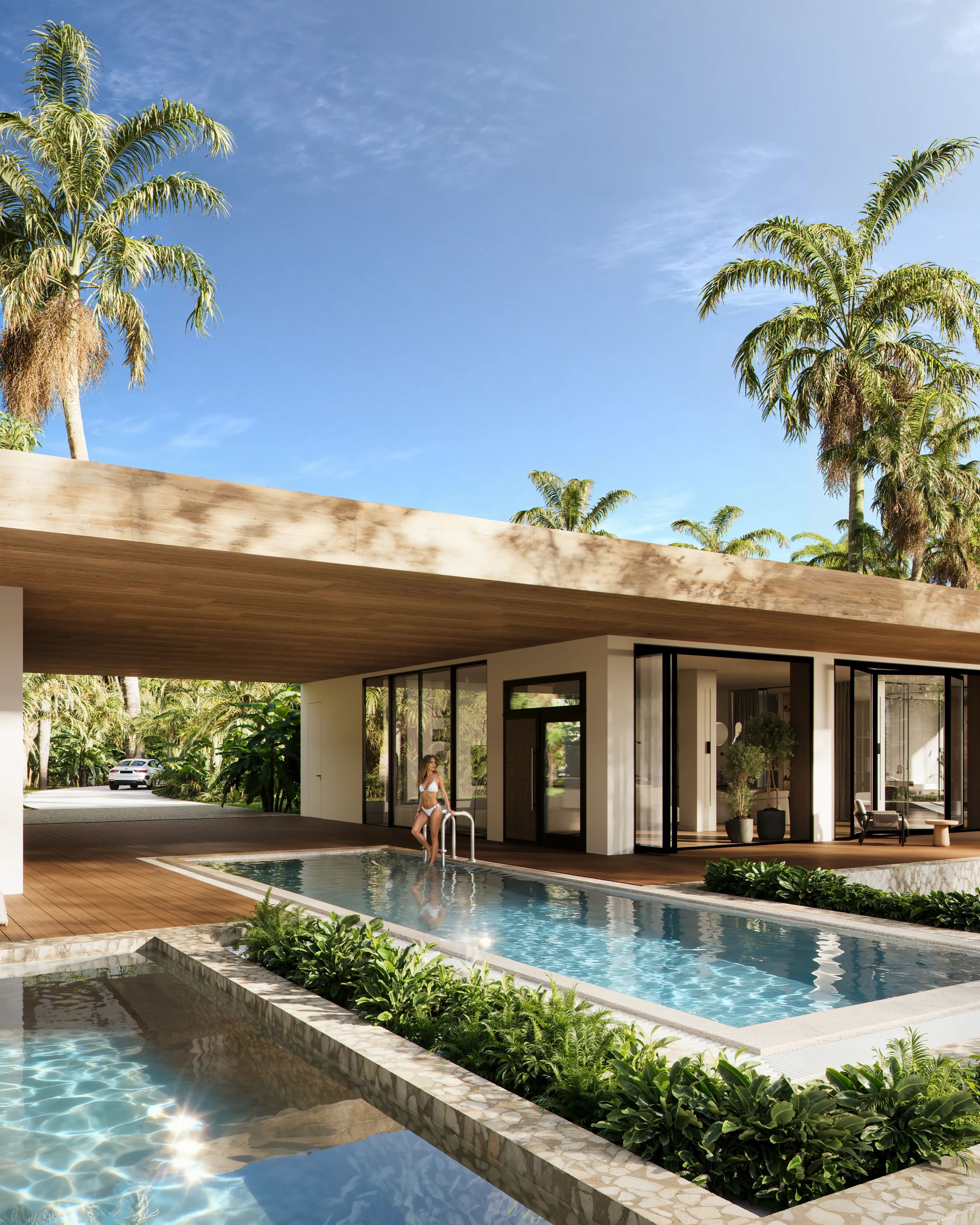 Modern villa entrance and pool area with a woman enjoying the tropical setting.