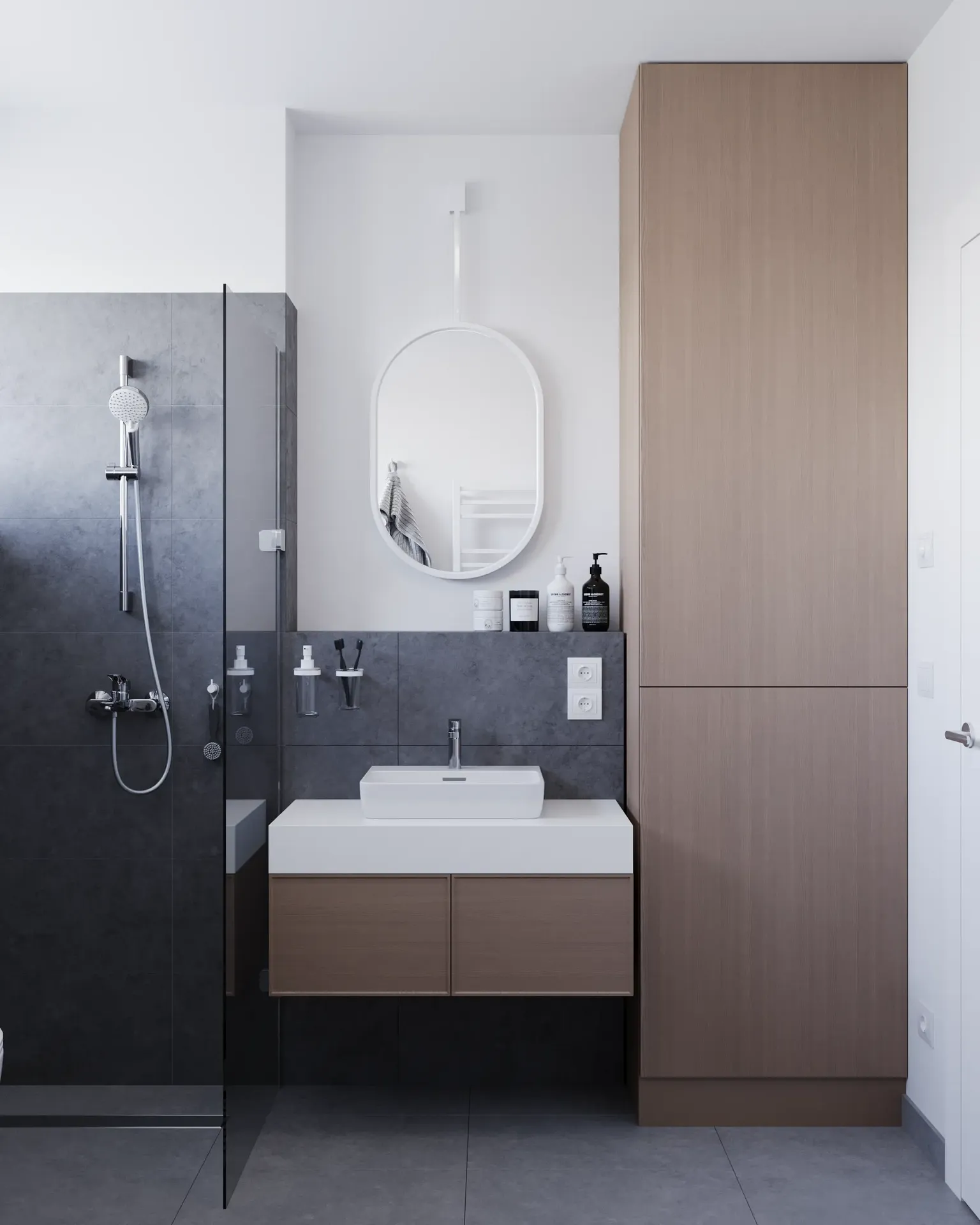 Salle de bains minimaliste avec carrelage gris foncé et vanité flottante en bois.
