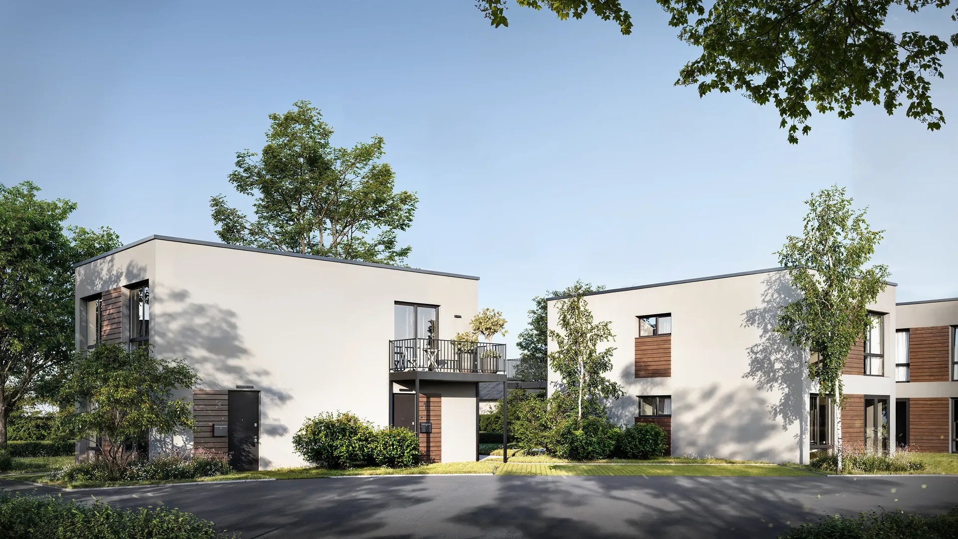 Vue inclinée de la façade avant et de l'entrée d'une résidence moderne.
