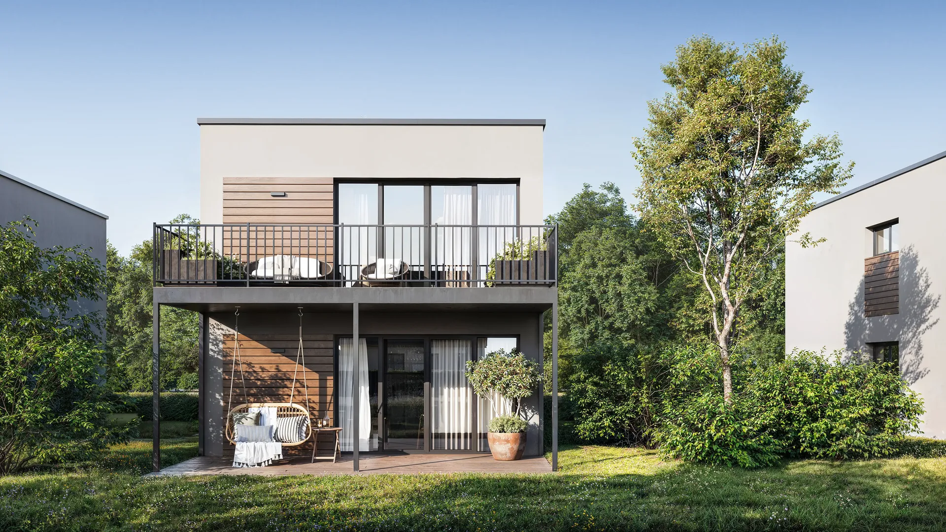 Vue de la façade avant d'une maison avec un espace terrasse paysagé.