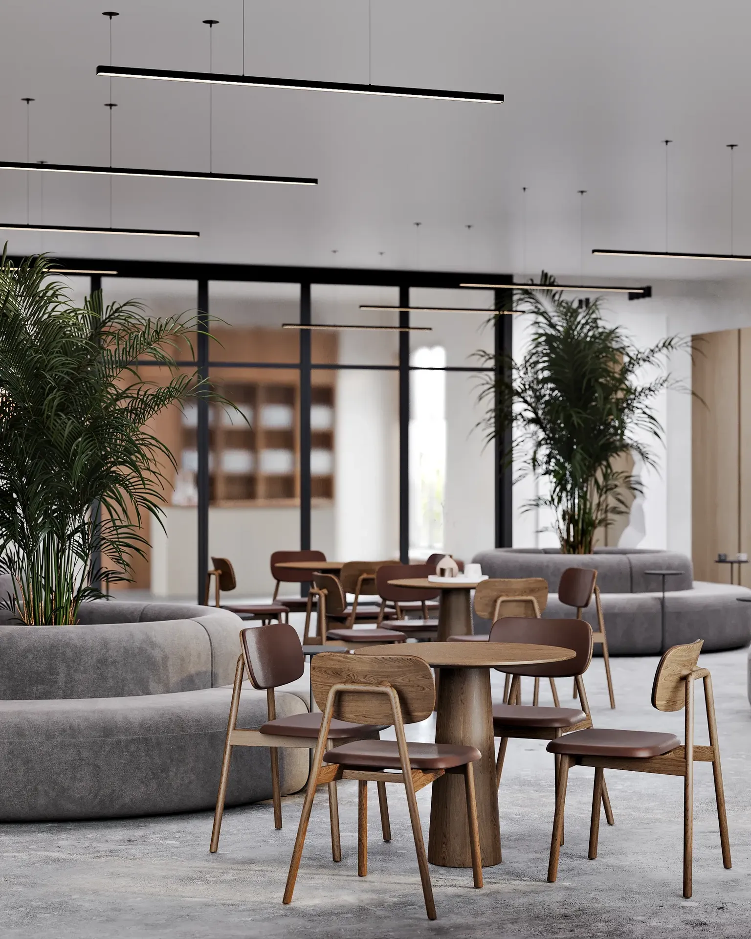 Café-Essbereich mit Tischen für vier Personen und stilvollen, runden Bankettsofas.