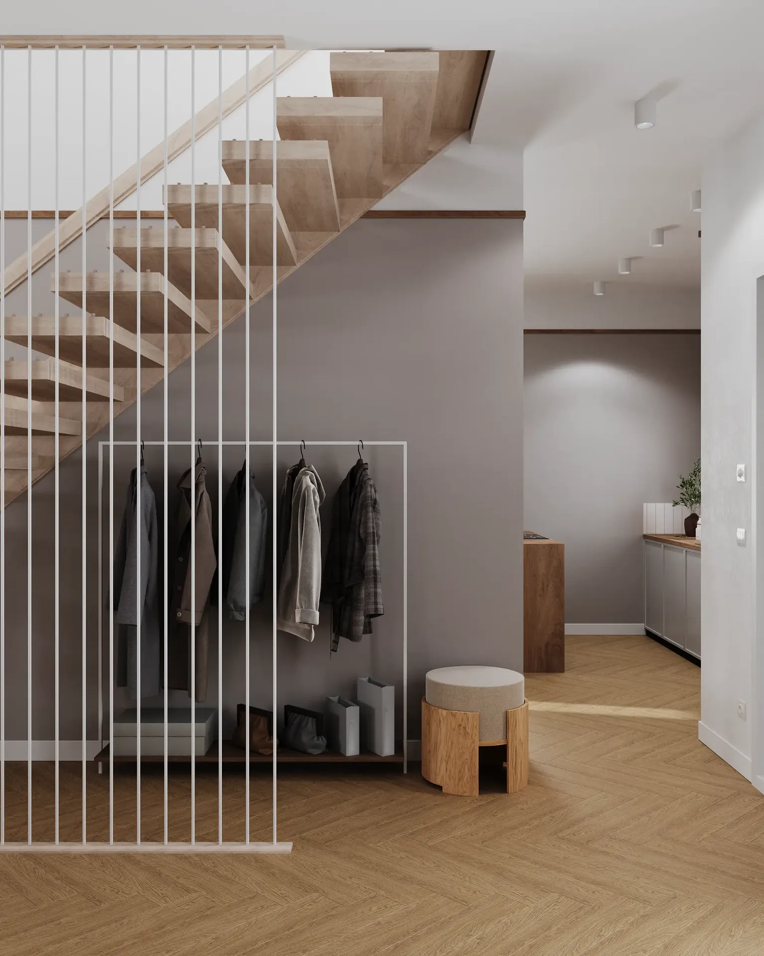 Vue d'un escalier, porte manteau, pouf et passage cuisine.