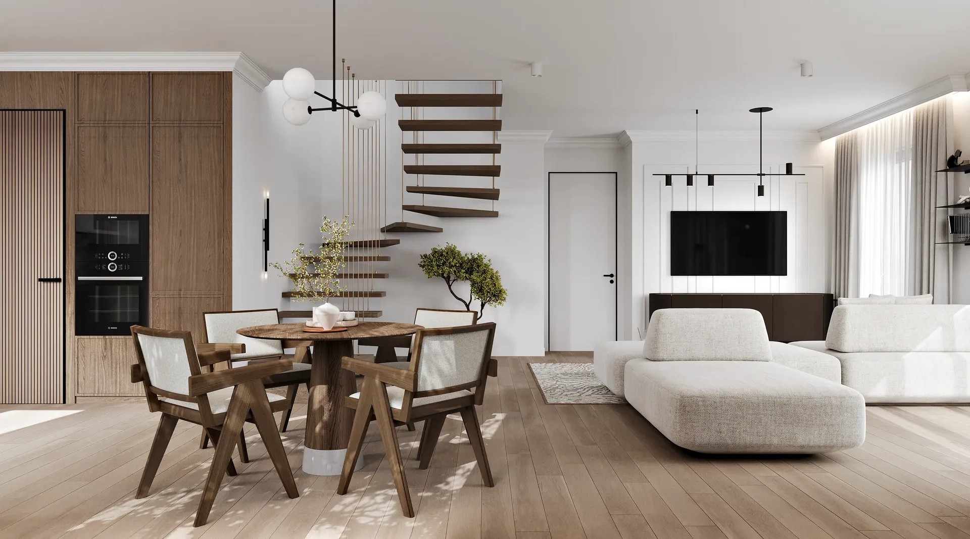 Weitblick auf einen offenen Wohnbereich mit Lounge, TV-Zone, Essbereich, Küche und Treppe.