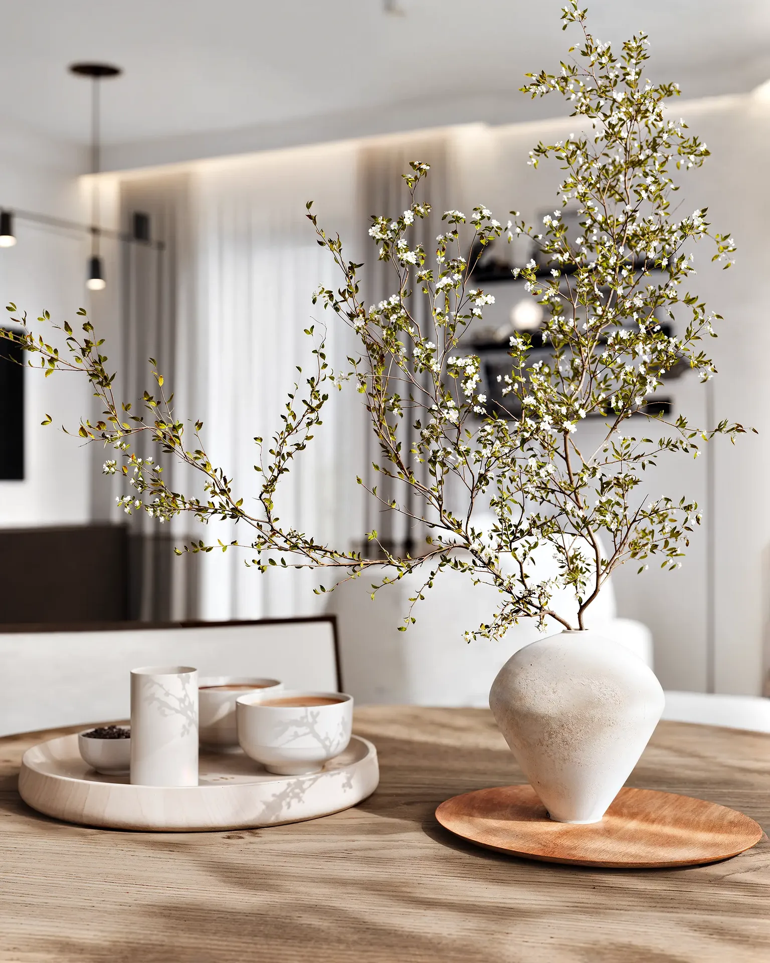 Primer plano de un elegante paisaje sobre una mesa de comedor, con un jarrón y platos modernos.