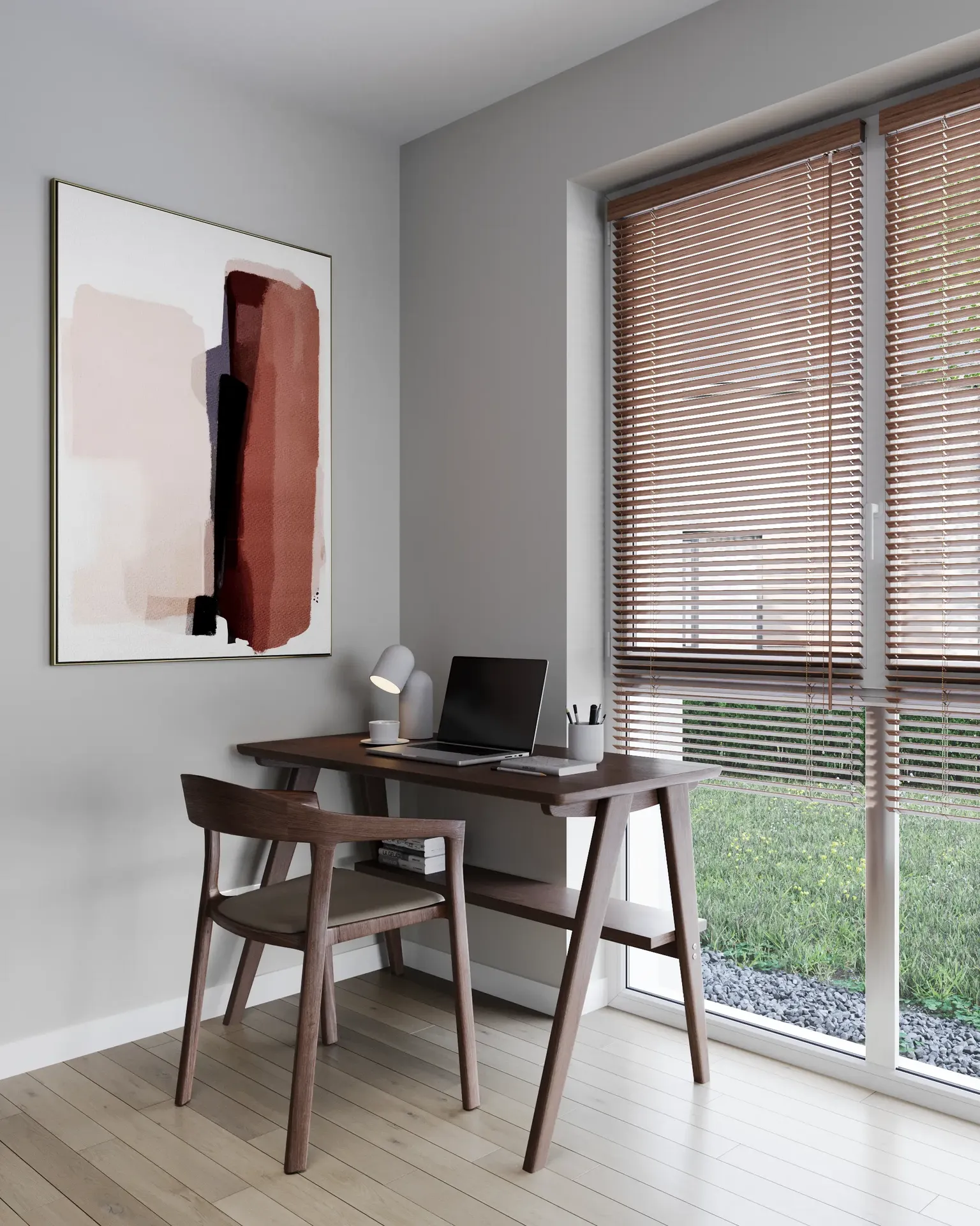 Vue en angle d'un espace de travail près de la fenêtre avec un bureau et une peinture.