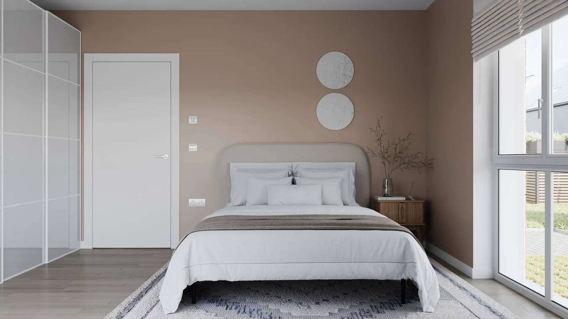 Vue de face d'un lit, d'une armoire et de l'entrée de la chambre.