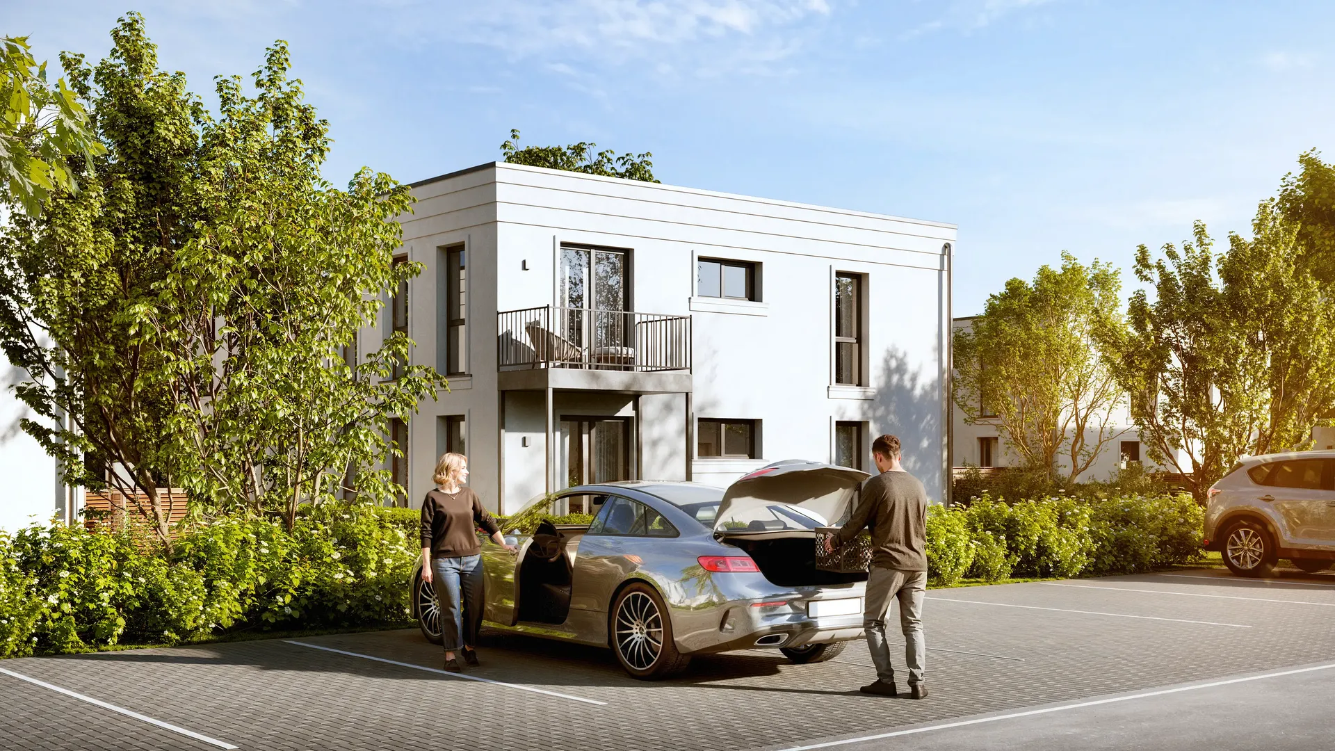 Vue horizontale des places de stationnement en plein air à proximité d'une maison résidentielle moderne.