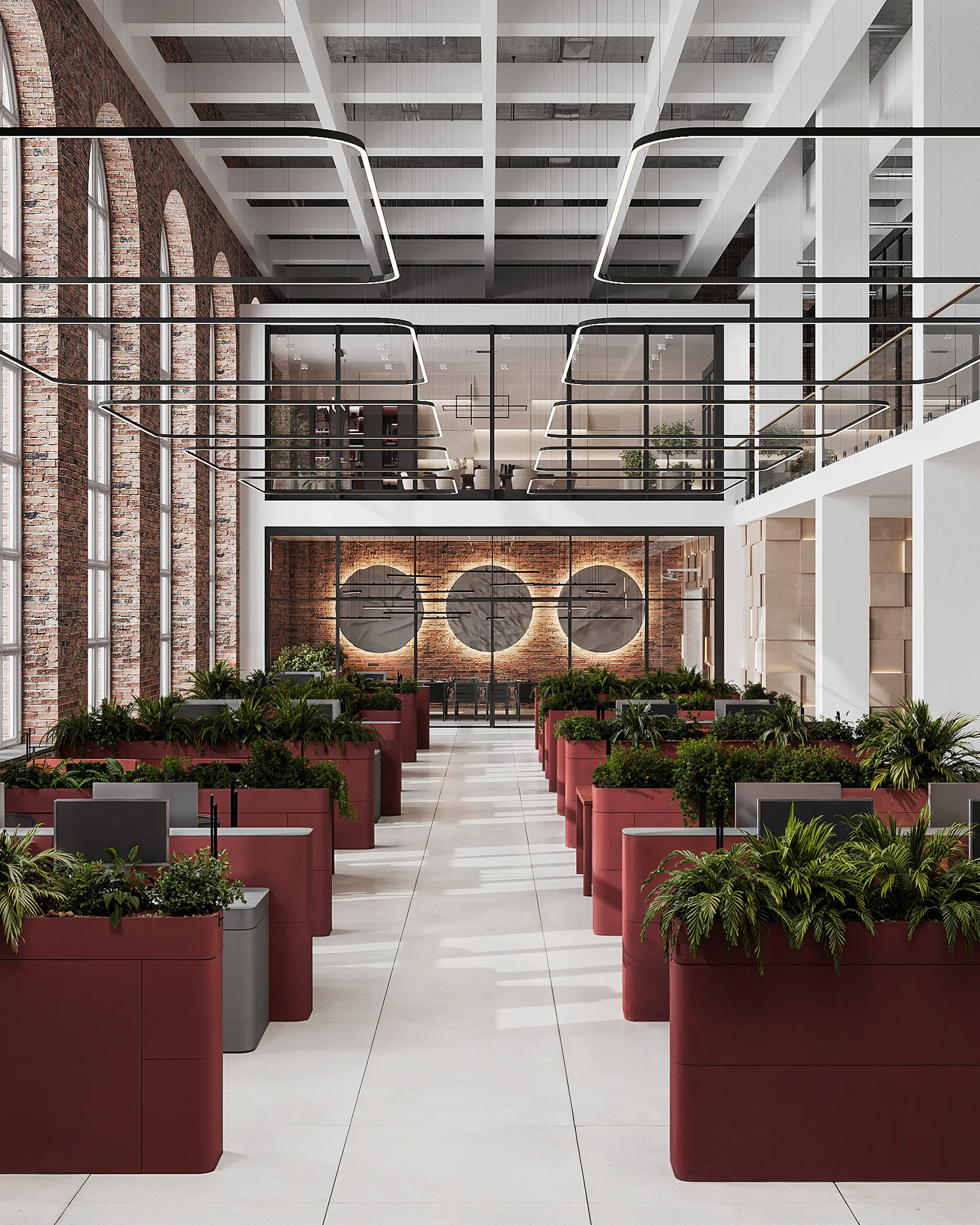 A bright, open-plan office with divided workstations, tall windows and a staircase to the mezzanine.