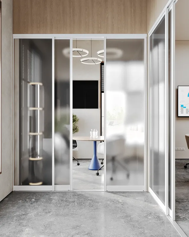 Frontal view into a modern, glass-walled meeting room set for four people.