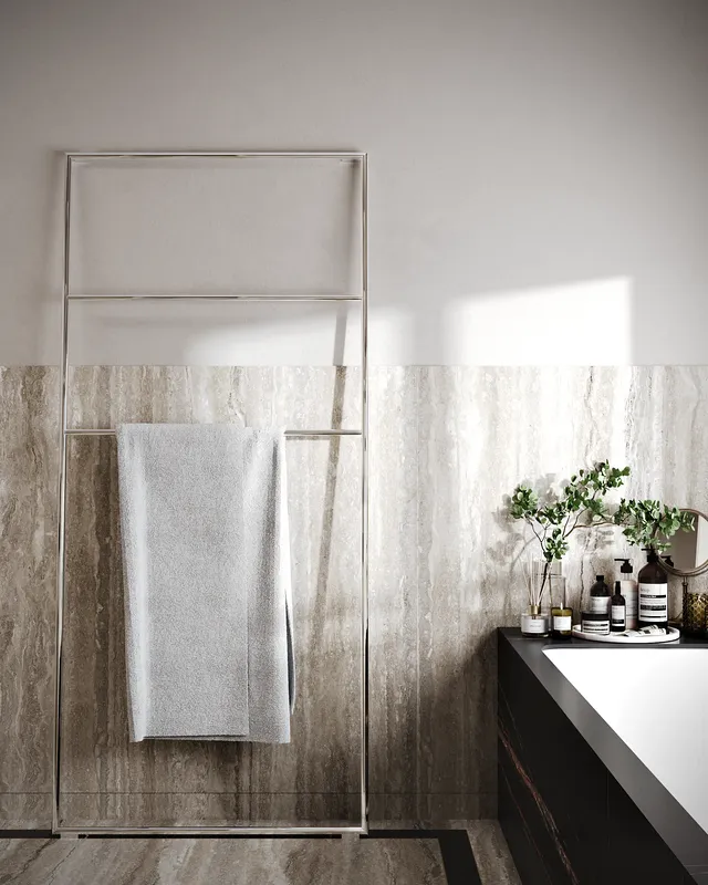 Detail shot of a sleek, black modern heated towel rail in the master bathroom.